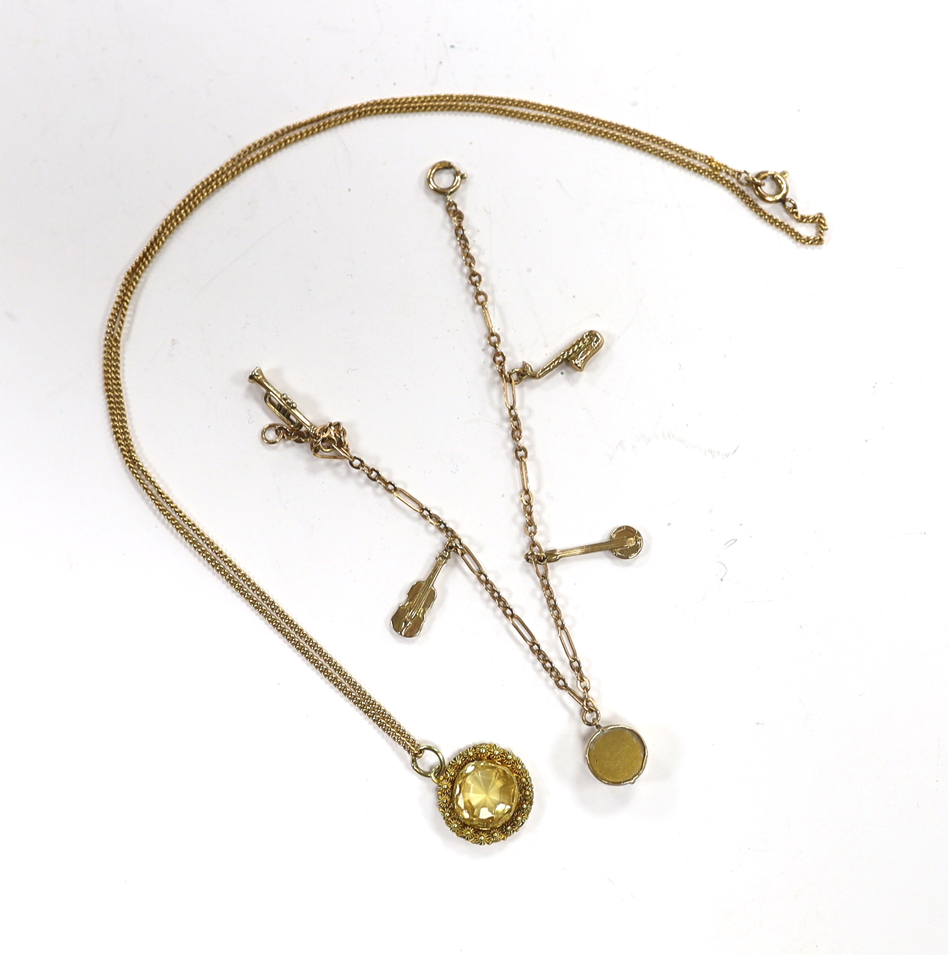 A small 9ct gold charm bracelet, hung with three assorted charms, gross weight 3 grams and a yellow metal and citrine set pendant on a 15ct chain, gross weight 5.5 grams.